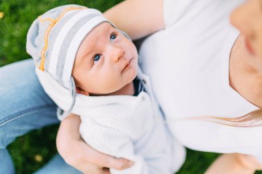 Happy family in the fresh air, mother with a baby in her arms
