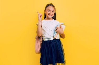 Teen girl child pointing finger up having a brilliant idea