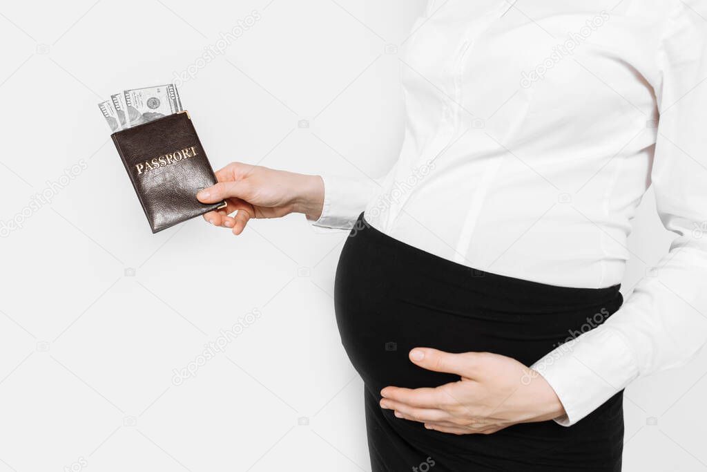 Pregnant woman holding passport with money, waiting for vacation, on white background