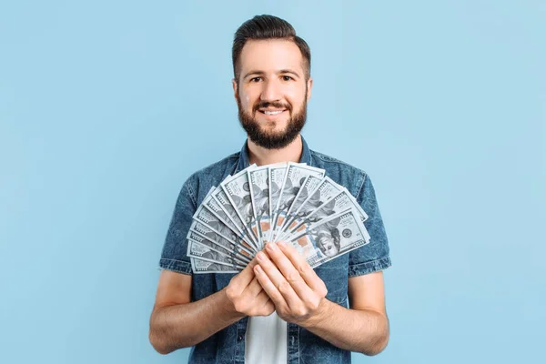 Cheerful Excited Young Man Poses Blue Background Holding Fan Cash — Stock Photo, Image