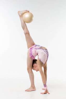 A young teenage girl in leotard shows gymnastic and ballet exercises on a white background. clipart