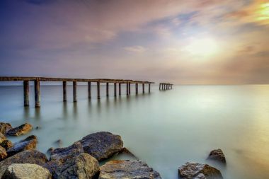 Bir uzun pozlama fotoğraf, terk edilmiş eski iskelesi ile bulutlu befor