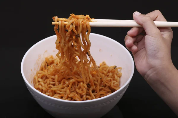 Cheese ramen noodles with chopstick on black background — Stock Photo, Image