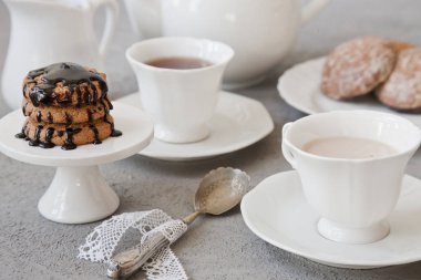 Beyaz fincan kahve süt ve çikolata Çerezler vintage tarzı arka plan tablo ile yakın çekim