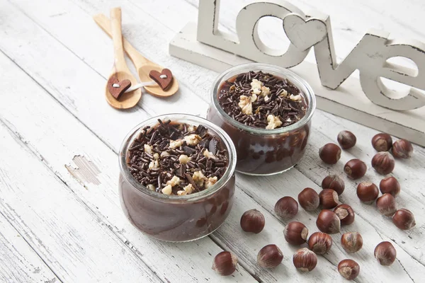 Chocolate yogurt on the table. Family breakfast, healthy food. Selective focus, close-up, shallow depth of field. Vintage white wooden background