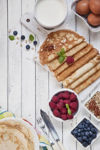 传统自制的煎饼与浆果在白色的老式木制背景 Maslenitsa — 图库照片