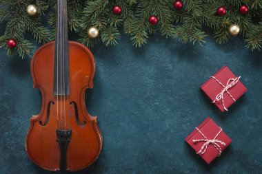 Old violin and fir-tree branches with Christmas decor. Christmas clipart