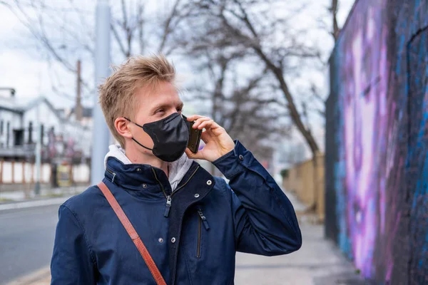 Avrupalı adam yüz maskesi takıyor. 