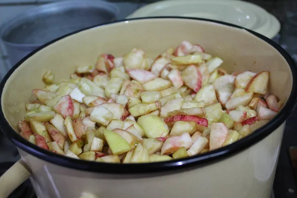Apple slices in a large saucepan / photo of apples in a saucepan.fruit cut into slices.they are ready to cook.cooking jam in the home kitchen.