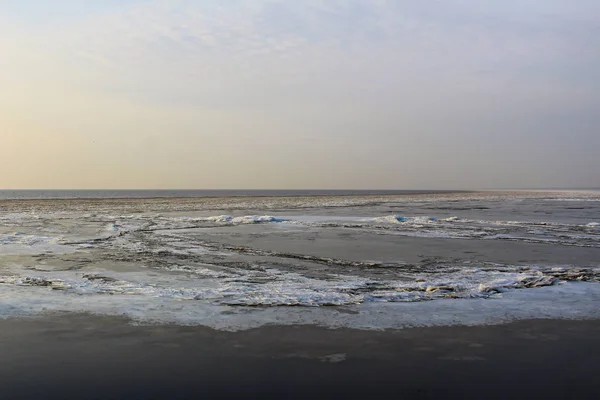 beautiful ice lake and cold winter sky / photo of ice White lake . the water in the reservoir froze . ice floes are thin and white. the sky is different colors. beautiful scenery.