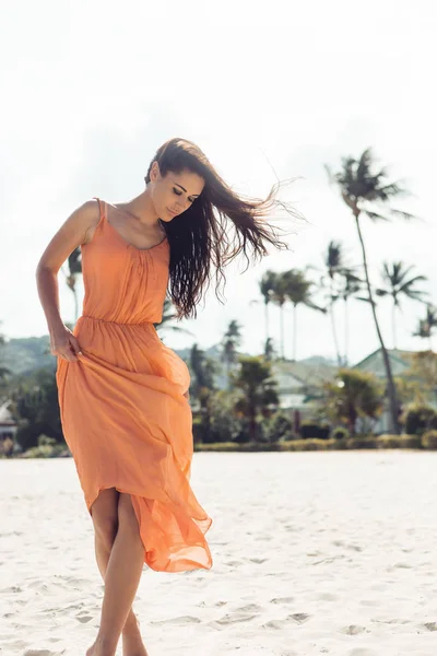 Pretty girl in summer dress on the beach.