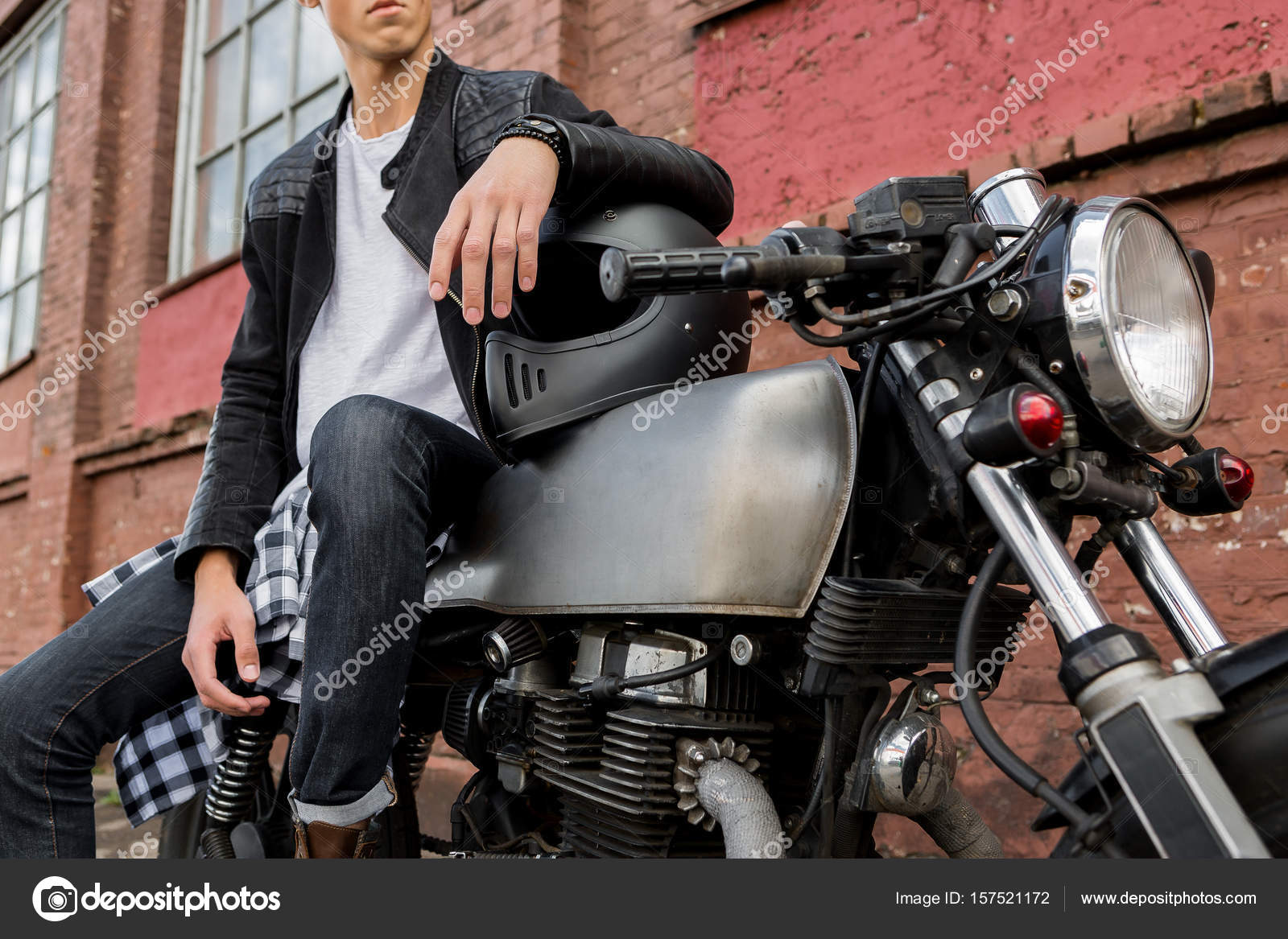 Close Up Of A Handsome Rider Biker Guy Hand In Black Leather Jacket On Helmet Classic Style Cafe Racer Motorcycle Bike Custom Made Vintage Garage