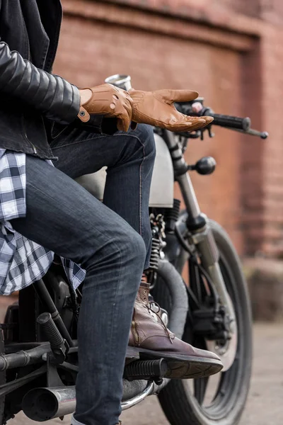 stock image Brutal man sit on cafe racer custom motorbike.