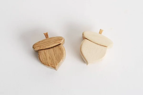 Wooden hand-made acorn toy for children isolated on the white background with shadow reflection. Wooden acorn for playing with kids. Natural typical wooden toy in the shape of cute acorn — Stockfoto