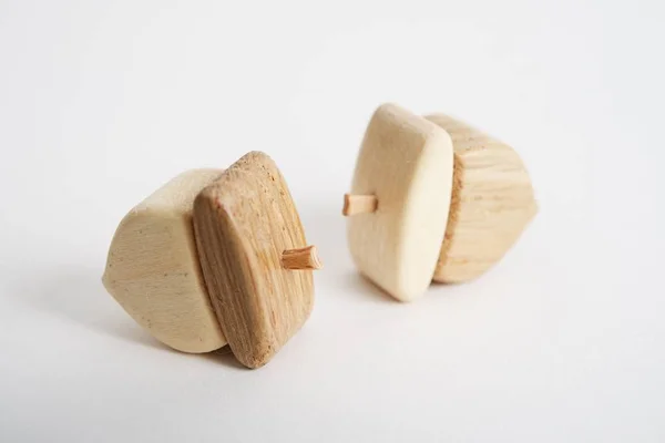 Wooden hand-made acorn toy for children isolated on the white background with shadow reflection. Wooden acorn for playing with kids. Natural typical wooden toy in the shape of cute acorn — Stockfoto