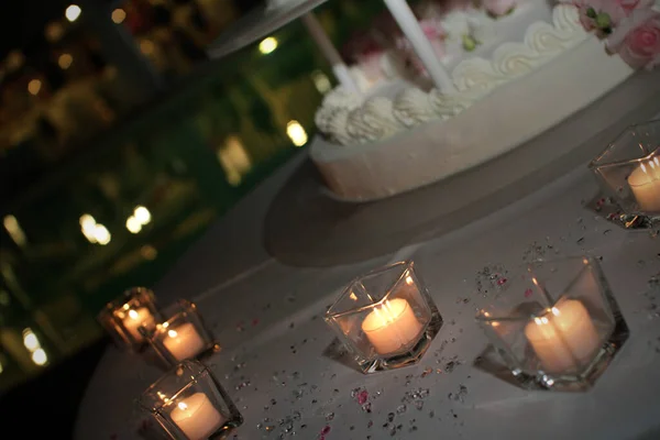 Wedding cake with candles and roses