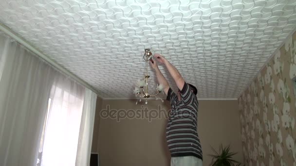 Man Hangs Chandelier Electricity — Stock Video