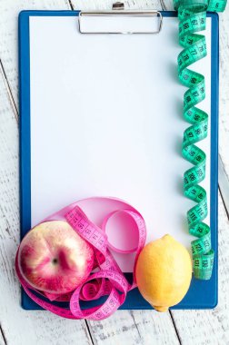 centimeter tape, Notepad with space for text. the concept of health, weight loss, diet, colony burning, overweight. minimalism, the view from the top.