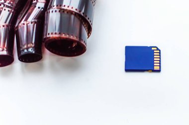 film and flash card on a white background. Concept of progress and development of technologies. Selective focus, film grain.
