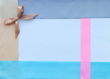 Template. Satin ribbons in blue, gray, pink and beige with a handmade heart, a bow on a white background with a place for the inscription. The concept of handmade.