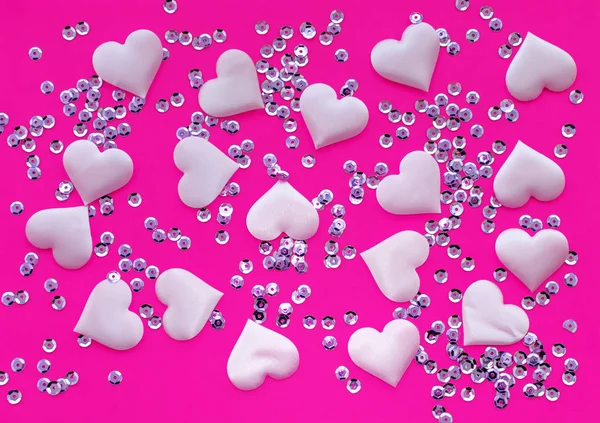 Texture. Satin pink hearts and sequins on a pink background. The view from the top. The concept of relationships and love. — Stock Photo, Image