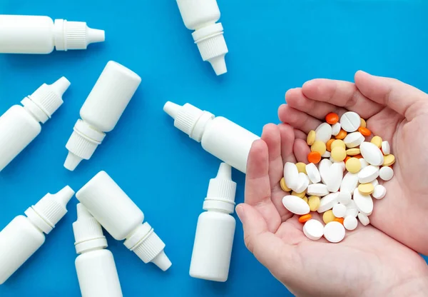 Hands Holding Handful Pills Background Bottles Nose Drops Blue Background — 스톡 사진