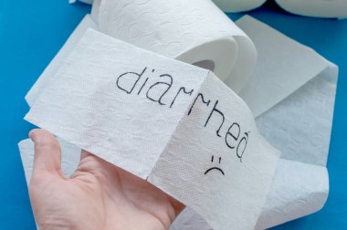 Tuvalet kağıdı. Tuvalet kağıdının arka planında ishal kelimesi var. Kapat..