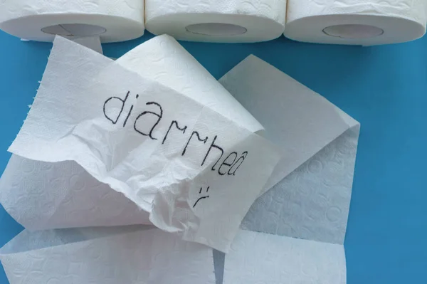 Rolls of white toilet paper labeled 