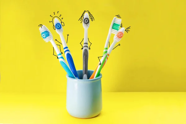 Colorful Toothbrushes Form Cartoon Characters Blue Glass Yellow Background Concept — Stock Photo, Image