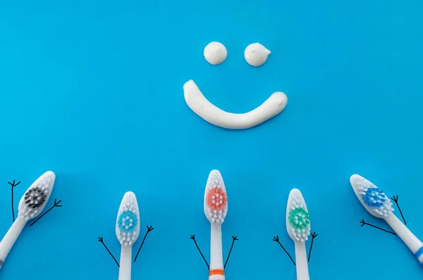 Colorful Toothbrushes Form Cartoon Characters Blue Background Smile Drawn Toothpaste — Stock Photo, Image