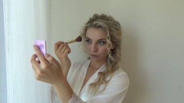 Kız düğünden önce yüzüne makyaj yapıyor.