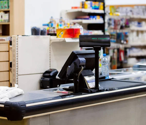 Cash desk with terminal in supermarket