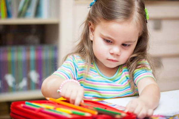 Happy little girl drawing with pencils — Stock Photo, Image