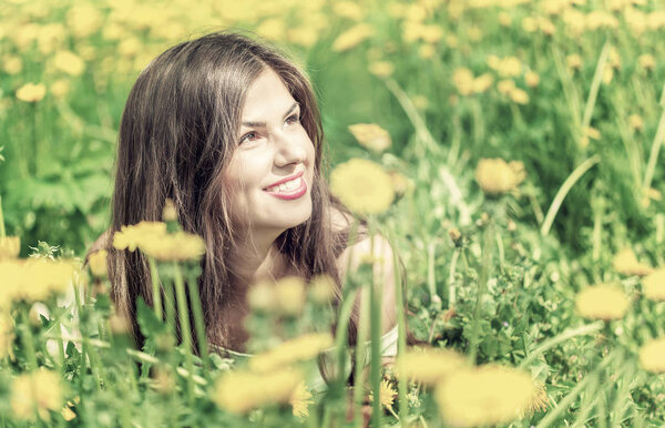 Young woman is lying on field