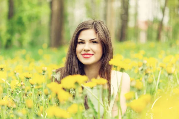 Young woman is lying on field — Stock Photo, Image