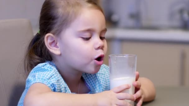 Маленькая девочка пьет молоко — стоковое видео