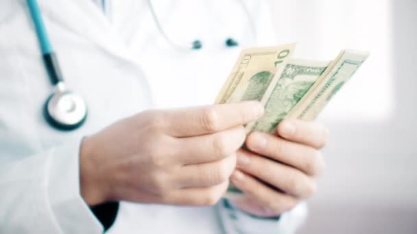 Corrupted doctor counting money and putting it into his pocket. UltraHD video — Stock Video