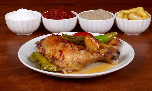 perfect turkish dish chicken leg spicy on white plate close up on wooden table