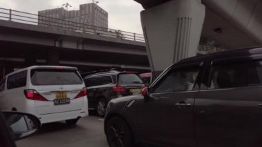Hong Kong, China - 2020: bus and cars drive slowly along the road