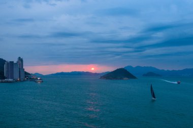 Beautiful landscape at sunset: sailing ship in the sea bay, aerial view