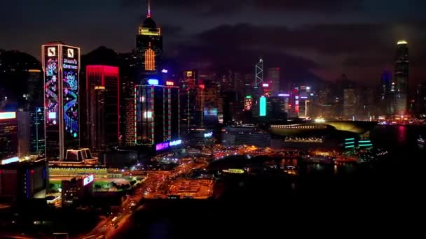 Hong Kong - 2020: timelapse, promenade, pier and skyscrapers at night from above — Stock Video