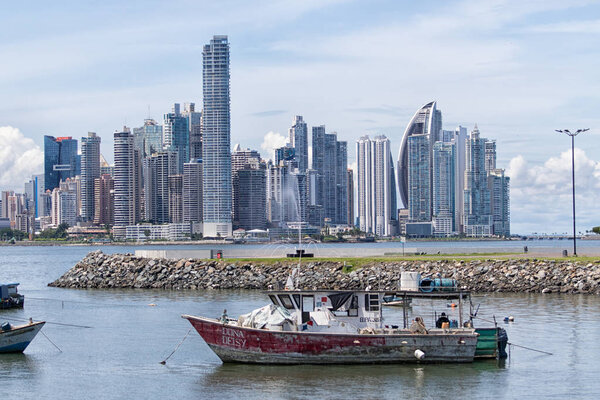 June 15, 2016 Panama City, Panama: small fishing boats floating on the water with the modern downtown highrise buildings in the background