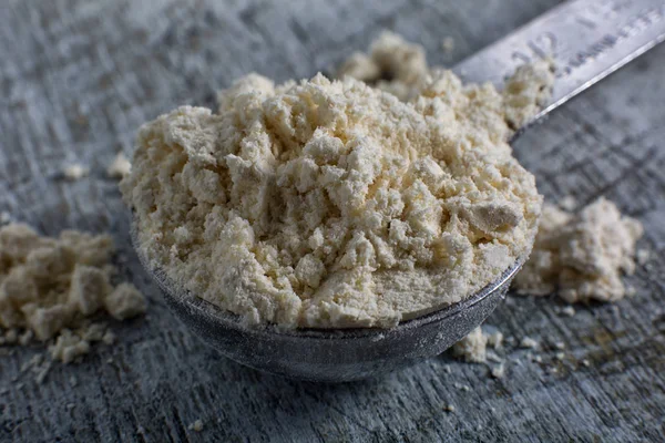 Chick pea flour closeup in measuring spoon — Stock Photo, Image