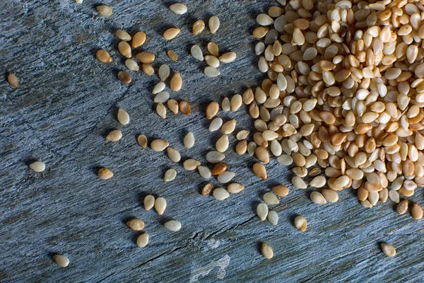 Sesame seeds on rustic wood surface — Stock Photo, Image