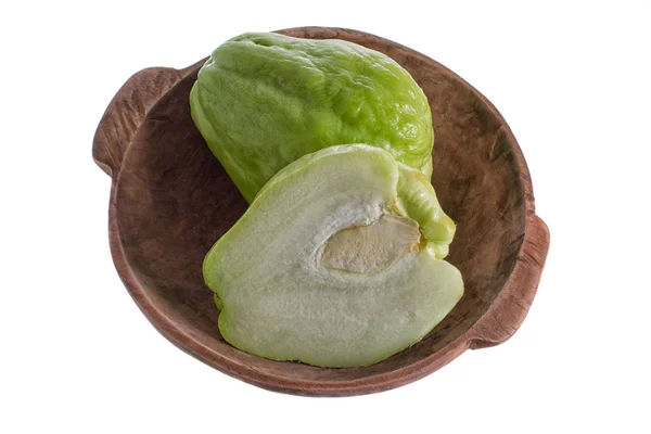 Isolated closeup of chayote in a rustic wooden bowl — Stock Photo, Image
