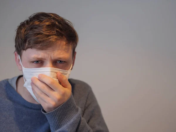 Egy jóképű fiatalember influenzás maszkban. — Stock Fotó