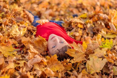 Sonbahar sarı yapraklı yakışıklı gencin yakın portresi.