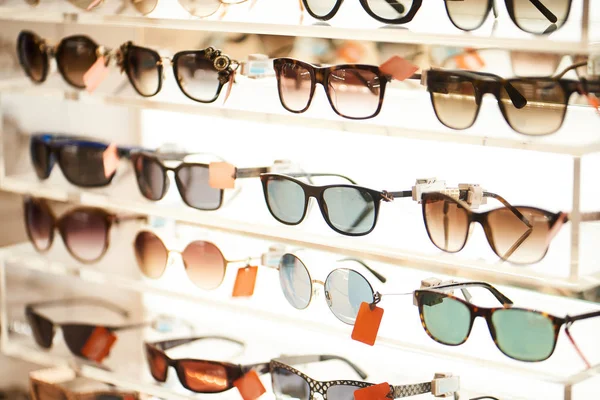 Modern sunglasses collection on shelves in store