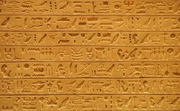 Closeup of old Egyptian hieroglyphs carved on stone