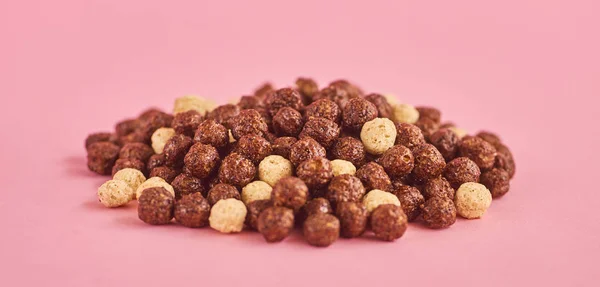 Cornflakes or cereal on pink background